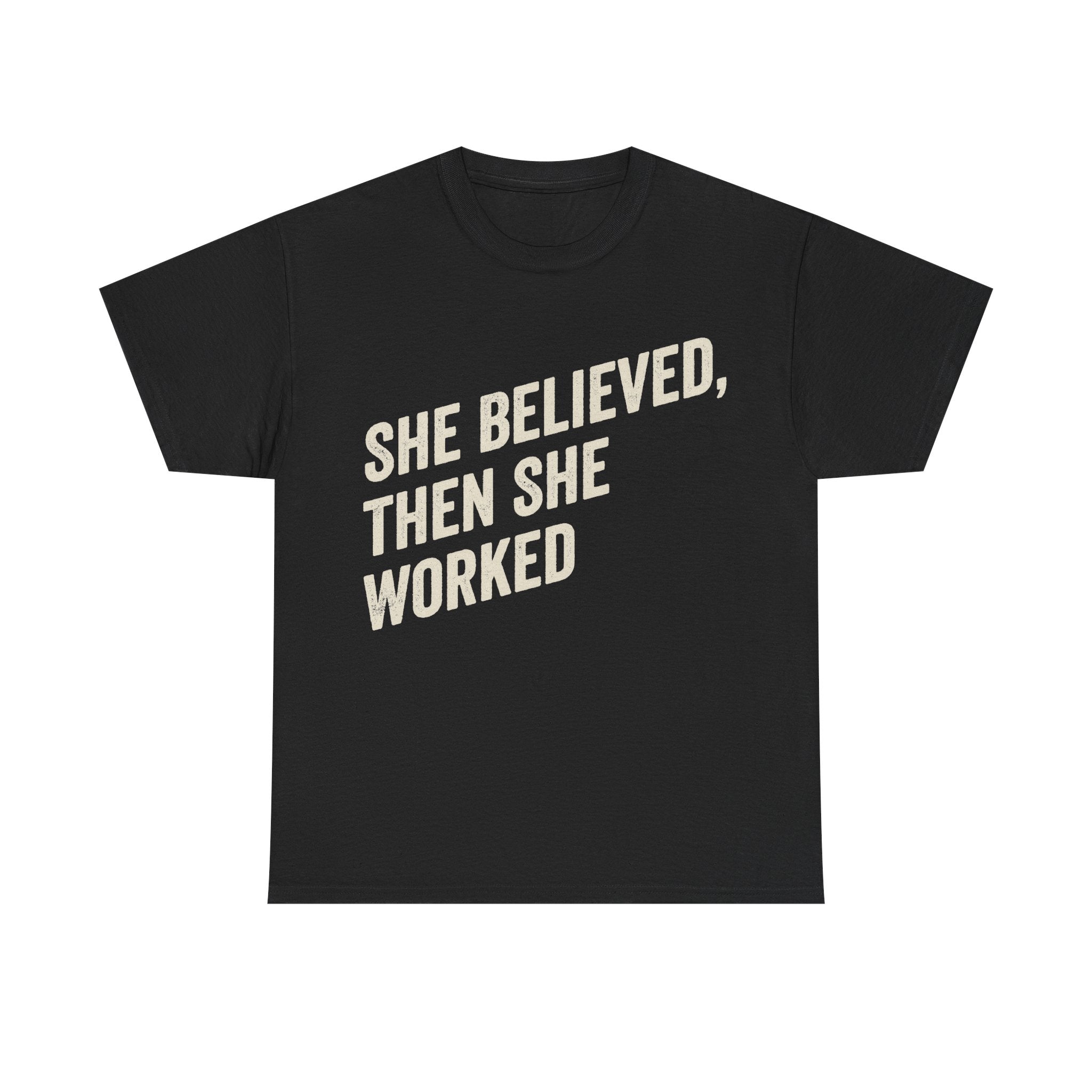 Black T-shirt with bold cream text reading SHE BELIEVED, THEN SHE WORKED; motivational women's career tee.