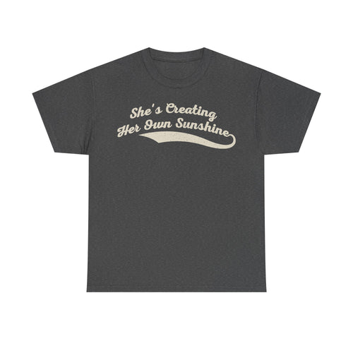 T-shirt in charcoal gray with cream vintage script reading She's Creating Her Own Sunshine