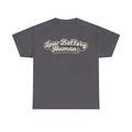 T-shirt with retro script typography reading Low Battery Human across chest on dark gray fabric, cream outline.