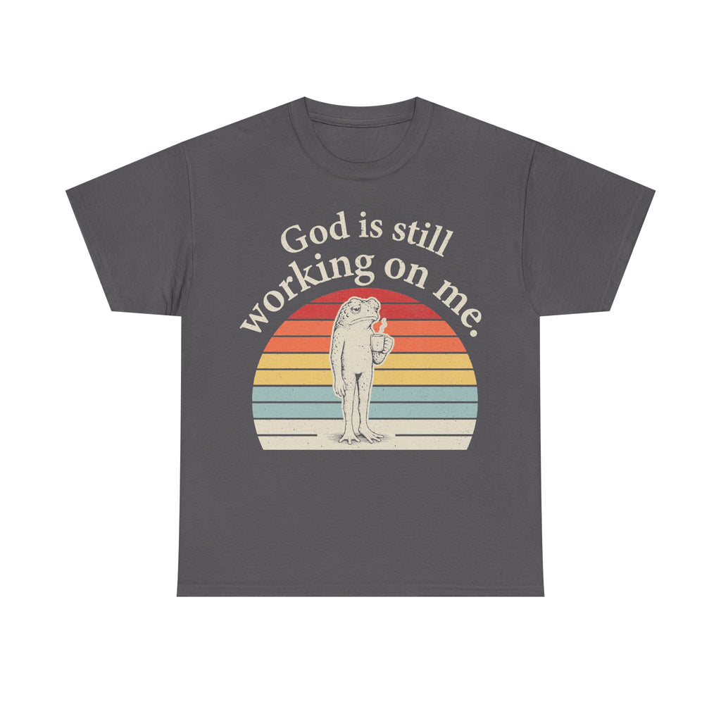 T-shirt gray with retro sunset circle frog graphic; God is still working on me.