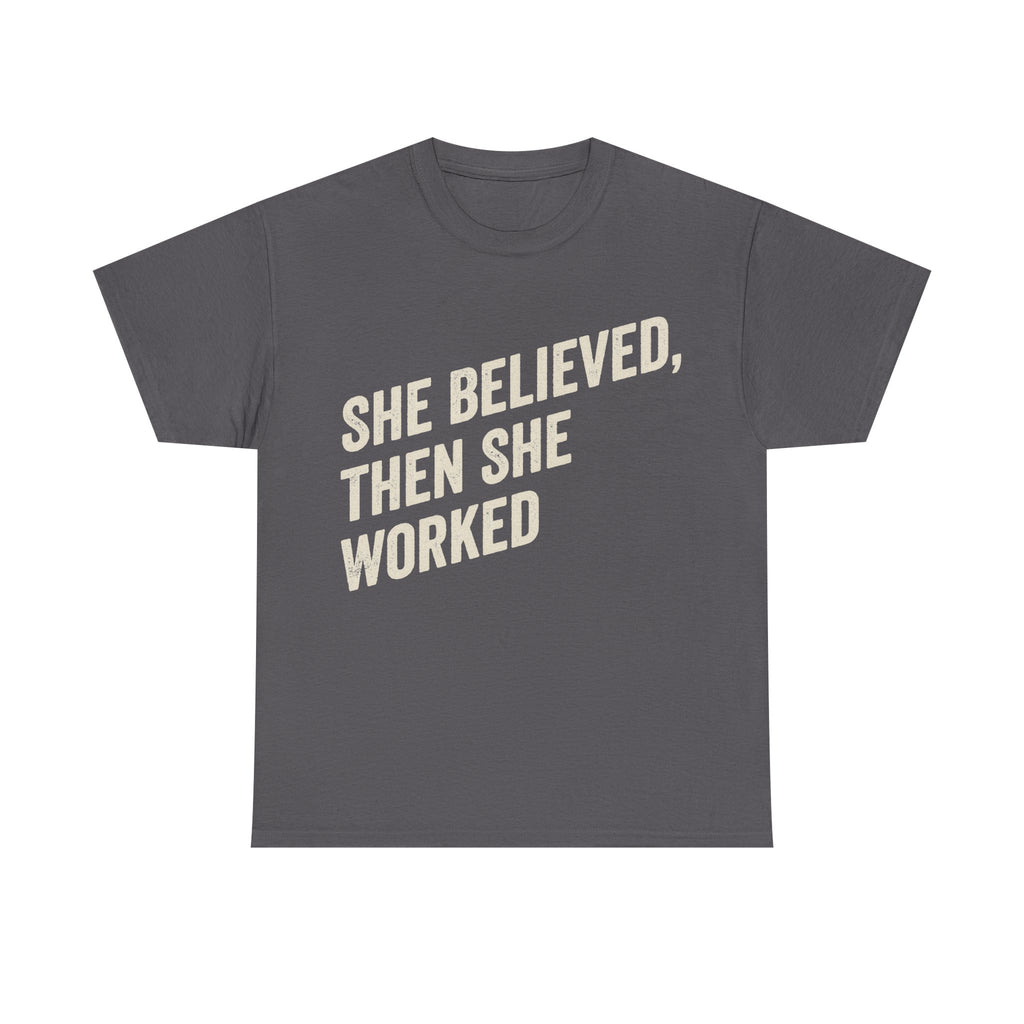 T-shirt, grey, bold cream text SHE BELIEVED, THEN SHE WORKED across the front of the shirt