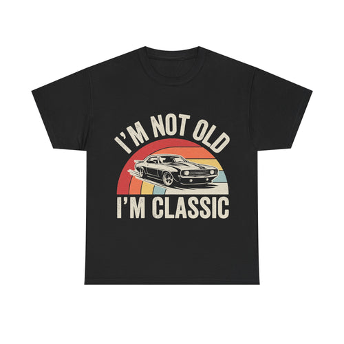 Black T-shirt with a vintage car cruising across a retro rainbow arc and the bold text I'M NOT OLD I'M CLASSIC.