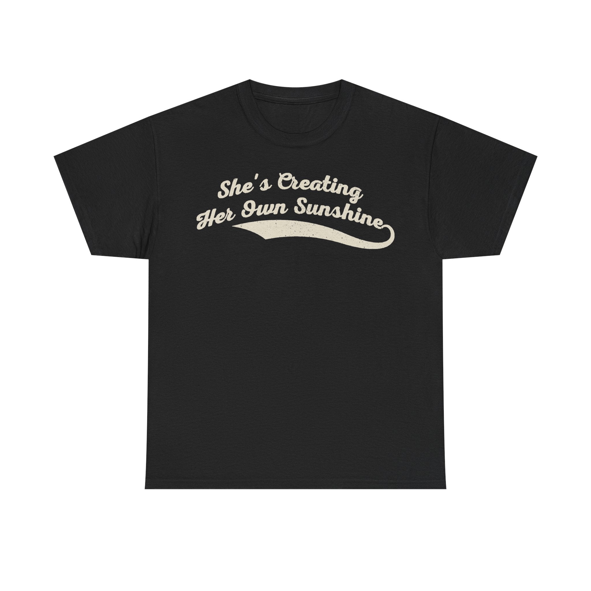 T-shirt in black with beige vintage script text She's Creating Her Own Sunshine across the chest.