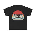 T-shirt, black, with retro sunset graphic and bold RESTING BEACH FACE slogan on front.