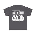 Dark gray T-shirt with white vintage tech graphic featuring floppy disk, cassette, VHS, and bold I’M THIS OLD typography.