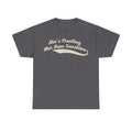 T-shirt in charcoal gray with cream retro script reading She's Creating Her Own Sunshine.
