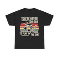 Black t-shirt with beige retro typography and a colorful striped panel showing gardening tools illustration.