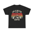 T-shirt with retro camping scene on black fabric: mountains, trees, campfire, and the curved text Life Is Better At The Campfire.