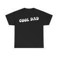 T-shirt with distressed white bubble-letter text COOL DAD on black fabric, retro style.