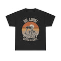 Black T-shirt with retro sunset circle and skeleton holding binoculars, displaying the bold text Oh, Look! Nobody Gives a Shit