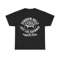 Black T-shirt with white distressed circular typography around a cinnamon roll illustration; text reads Synonym Rolls Just Like Grammar Used To Make.