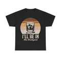 Black T-shirt with a retro whiskey glass and orange sunset graphic; features the text I'll Be In The Backyard.