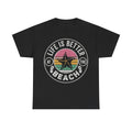 Black T‑shirt with retro circular design featuring a pink starfish, rainbow sunset stripes and Life Is Better At The Beach text