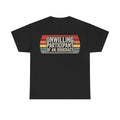 T-shirt on black fabric with retro sunset stripes and bold UNWILLING PARTICIPANT OF AN IDIOCRACY across the front